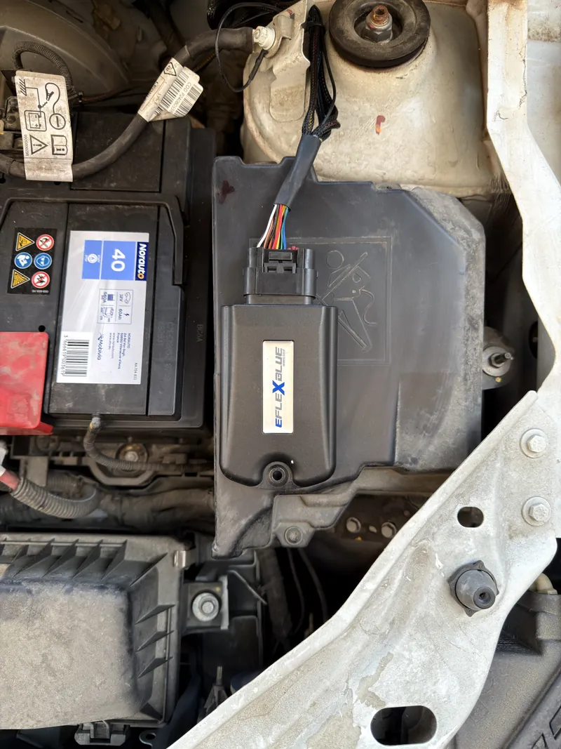 Boîtier eFlexBlue homologué fixé à côté de la batterie de la Dacia Sandero, connecteur et faisceau gainé raccordés